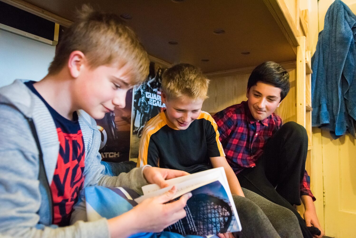 boarding students reading on bunk bed